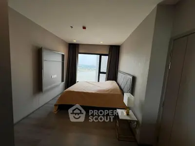 Modern bedroom with large window offering stunning city view