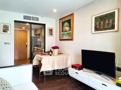 Charming living room with modern decor and open kitchen layout