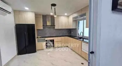 Modern kitchen with sleek cabinetry and built-in appliances in a stylish apartment.