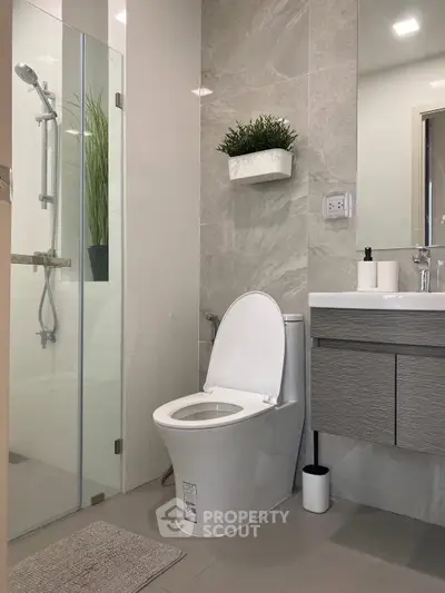 Modern bathroom with sleek fixtures and glass shower enclosure