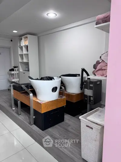 Modern salon interior with stylish wash stations and sleek shelving