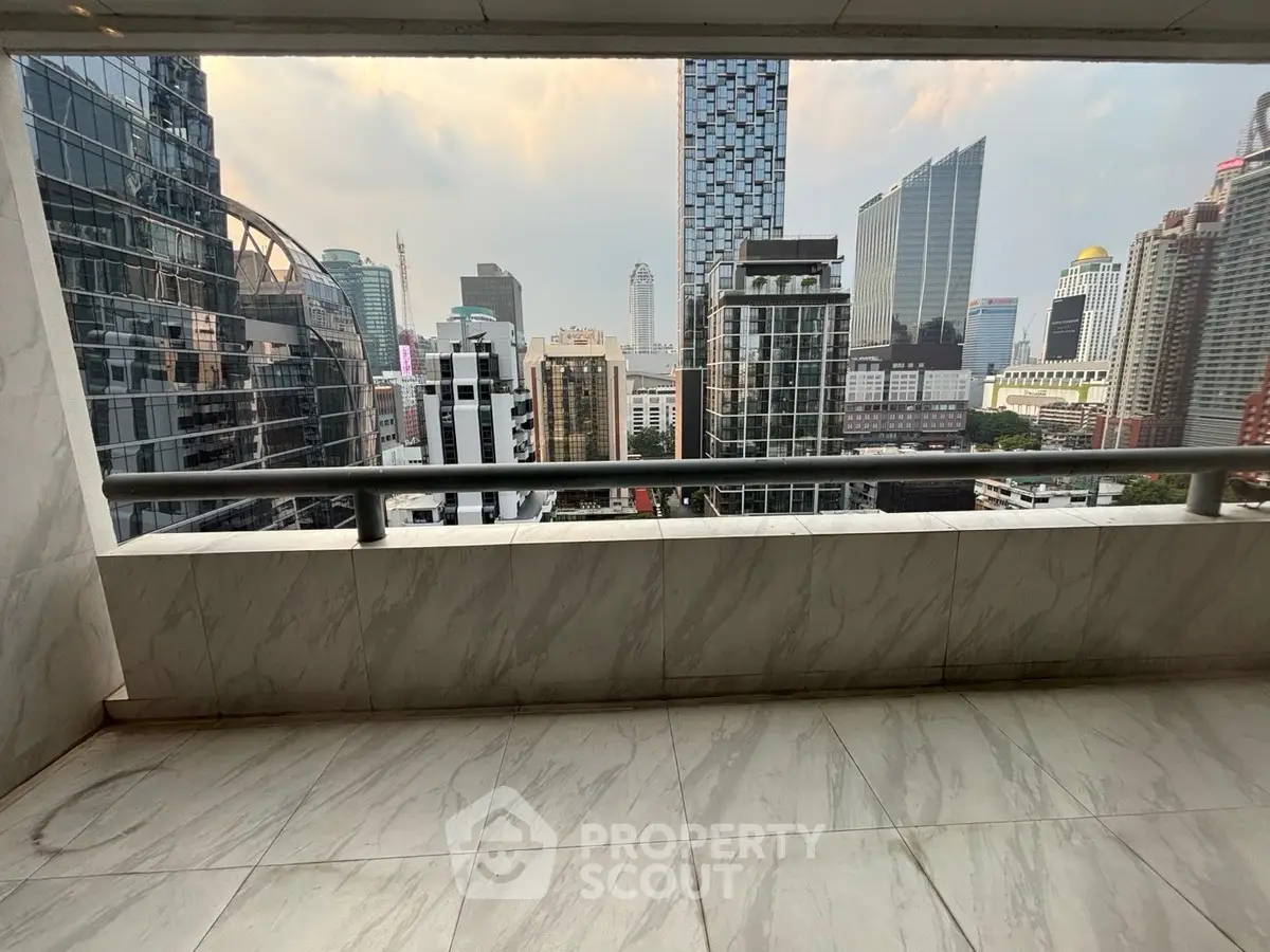 Spacious balcony with stunning cityscape view in modern high-rise building.