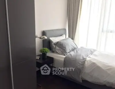 Modern bedroom with sleek design and natural light, featuring a cozy bed and stylish decor.