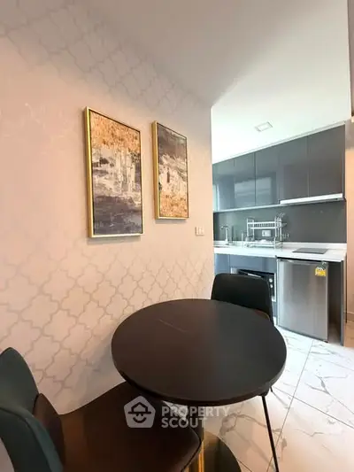 Modern kitchen with sleek appliances and stylish dining area