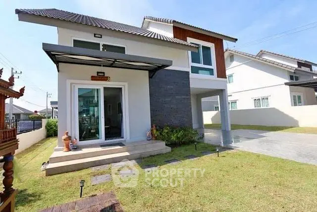 Modern two-story house with spacious driveway and manicured lawn in a serene neighborhood.