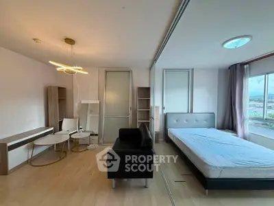 Modern studio apartment with stylish furniture and large window view