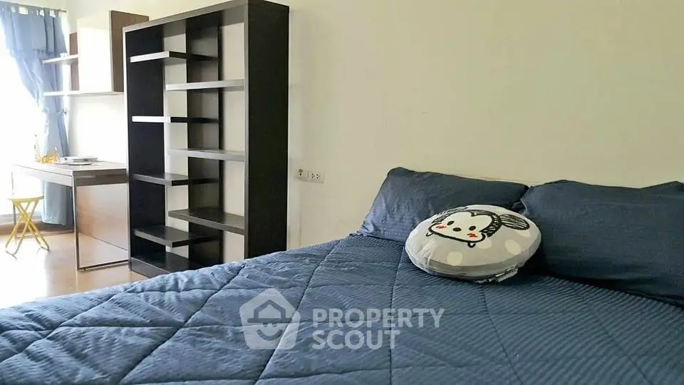 Cozy bedroom with modern shelving and stylish decor, perfect for relaxation and comfort.