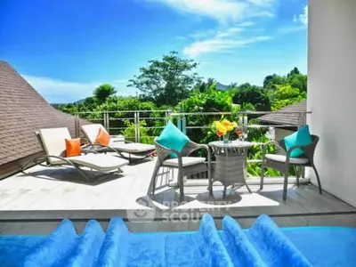 Luxurious balcony with pool and lush greenery view, perfect for relaxation.