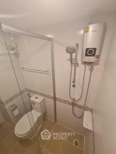 Modern bathroom with glass shower enclosure and water heater