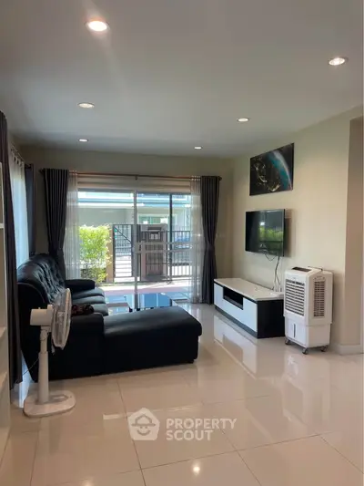 Spacious living room with modern decor and large windows for natural light.