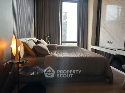 Luxurious bedroom with modern decor and large windows offering stunning city views.