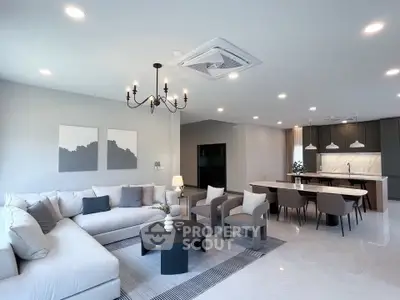 Spacious modern living room with elegant decor and open kitchen layout