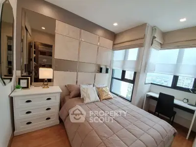 Modern bedroom with stylish decor and city view, featuring a cozy bed and functional workspace.
