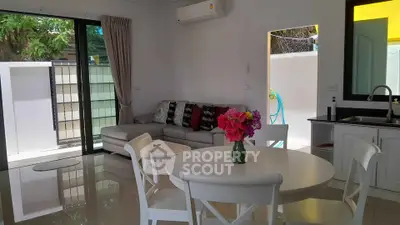 Charming living room with modern decor and garden view, perfect for relaxation and entertaining.