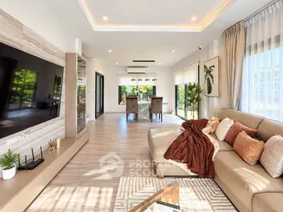 Luxurious modern living room with elegant decor and large windows offering natural light.