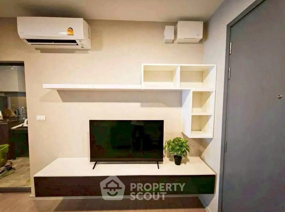 Modern living room with wall-mounted TV and air conditioning unit