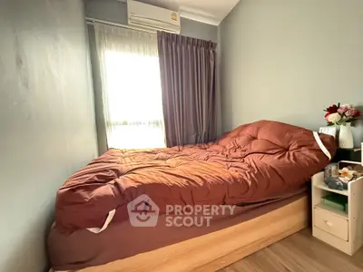 Cozy bedroom with natural light and modern decor, perfect for relaxation.