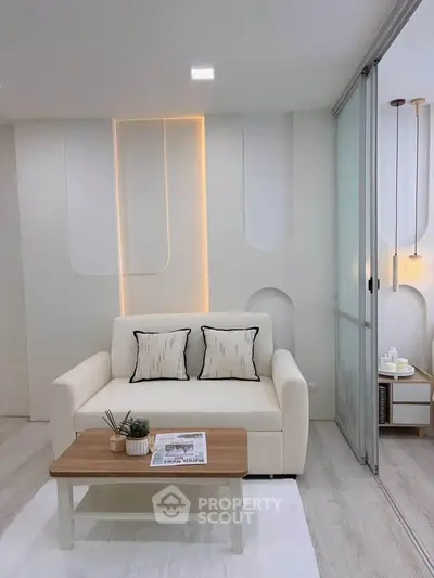 Modern living room with elegant sofa, stylish decor, and ambient lighting