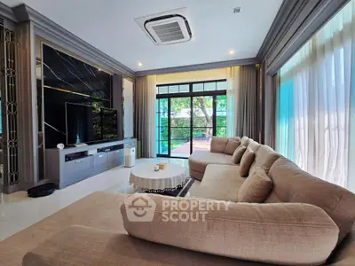 Luxurious living room with large windows and elegant decor