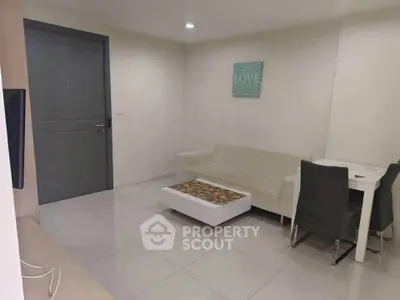 Modern living room with minimalist decor and cozy seating area.