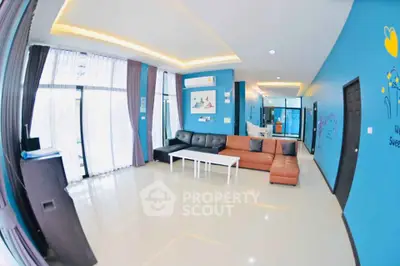 Spacious modern living room with stylish decor and ample natural light