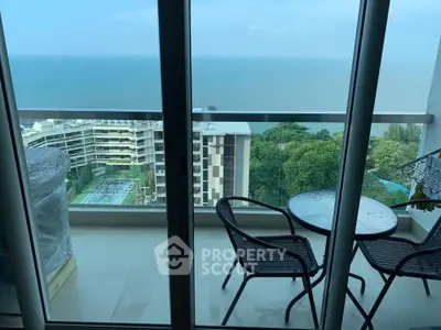 Stunning balcony view with ocean and cityscape, perfect for relaxation and enjoying the scenery.