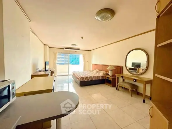 Spacious studio apartment with modern furnishings and natural light.