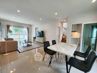 Spacious modern living room with dining area and large windows
