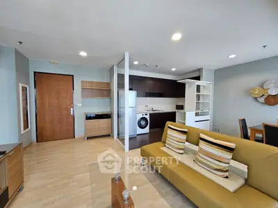 Modern open-plan living room with stylish kitchen and cozy seating area, perfect for urban living.