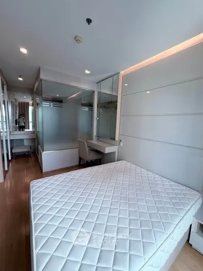Modern bedroom with sleek design and ample natural light, featuring a comfortable bed and stylish furnishings.