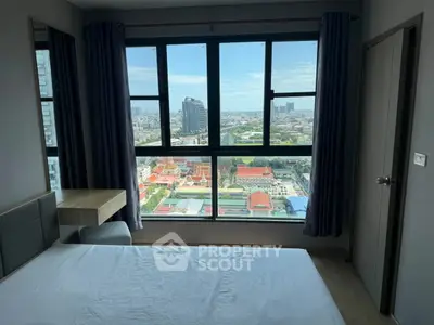 Stunning bedroom with panoramic city view from high-rise apartment window.