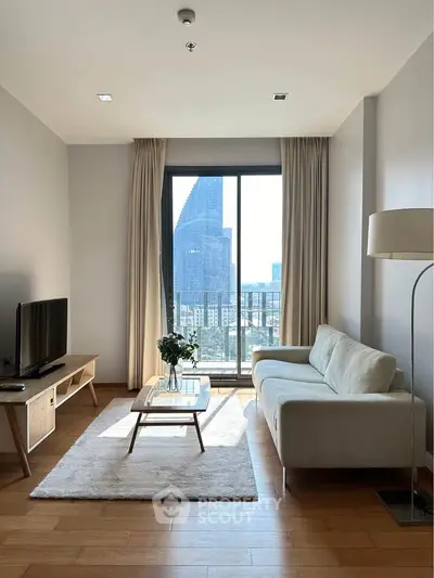 Modern living room with large window offering stunning city view, cozy sofa, and stylish decor.