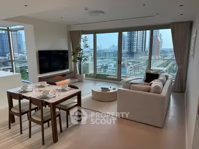 Luxurious living room with stunning city view, modern furniture, and elegant decor in a high-rise apartment.