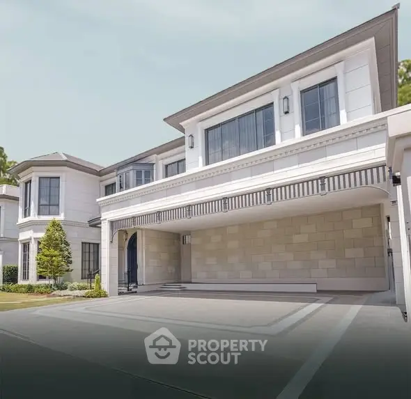 Luxurious modern home exterior with spacious driveway and elegant architectural design.