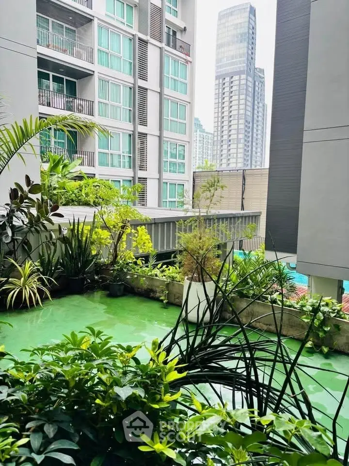 Modern urban apartment with lush green balcony and city view