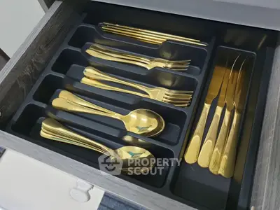 Luxury kitchen drawer with elegant gold cutlery set