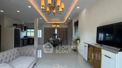 Spacious open-plan living room with modern kitchen and elegant dining area.