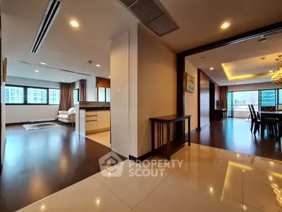 Spacious modern apartment with open layout, featuring elegant living and dining areas, and large windows for natural light.