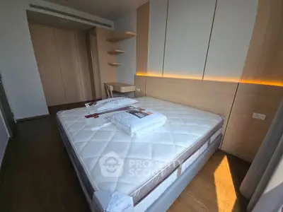 Modern bedroom with stylish wooden accents and cozy lighting, featuring a comfortable bed and built-in storage.