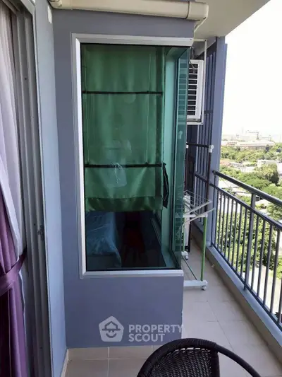 Modern balcony with glass enclosure and scenic view in high-rise apartment