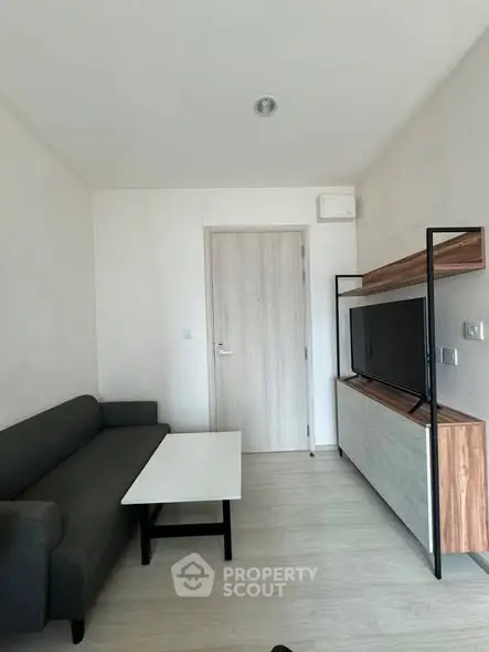 Modern minimalist living room with sleek furniture and neutral tones.