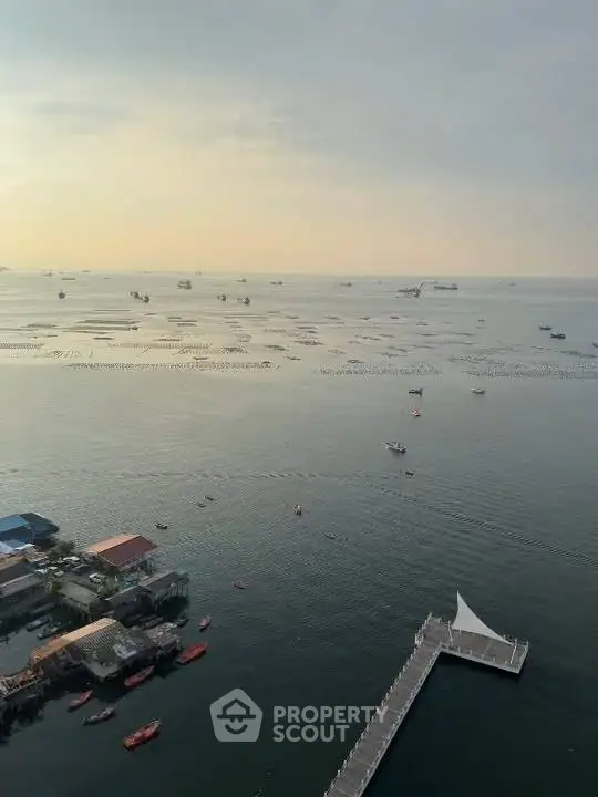 Stunning ocean view from high-rise building with serene waters and distant boats.