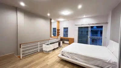 Spacious modern bedroom with balcony access and stylish decor
