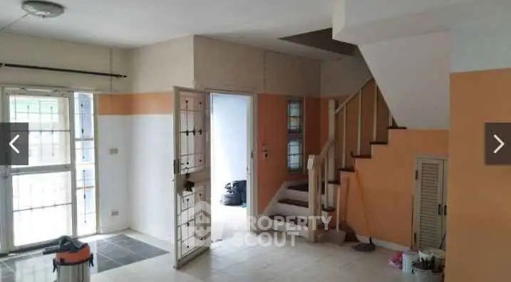 Spacious interior with staircase and natural light, ideal for modern living.