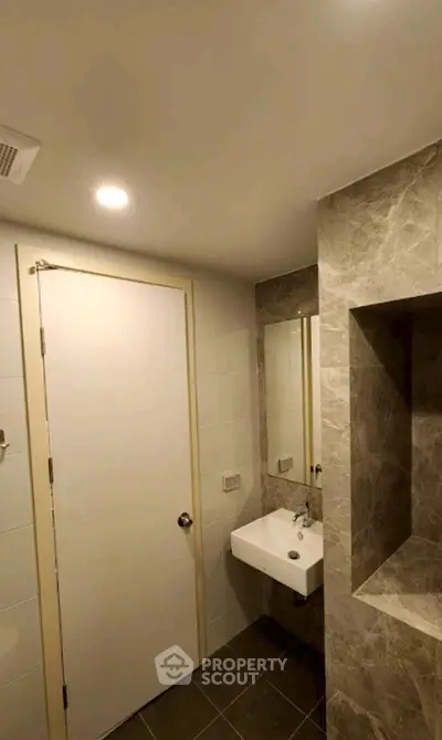 Modern bathroom with sleek sink and marble accents