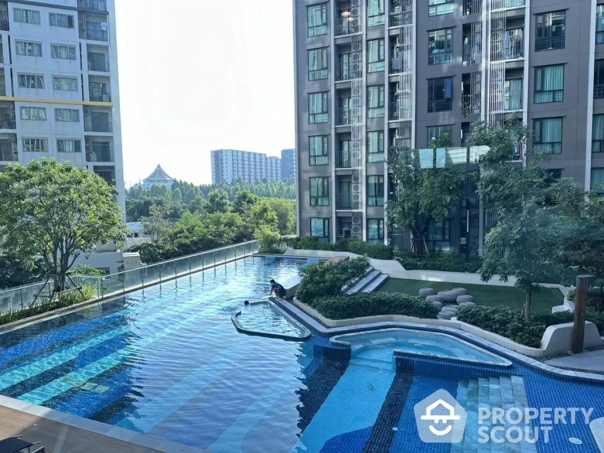 Luxurious condominium with stunning pool and lush garden view