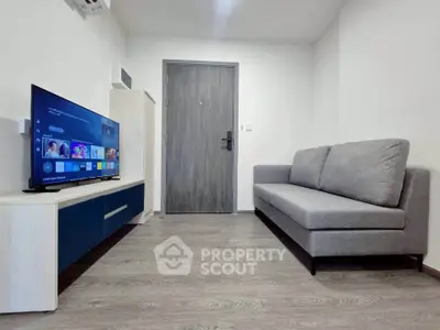 Modern living room with sleek furniture and smart TV setup, perfect for cozy entertainment.