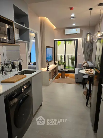 Modern open-plan kitchen and living area with sleek appliances and stylish decor