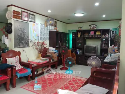 Charming living room with traditional wooden furniture and vibrant decor, perfect for cozy family gatherings.
