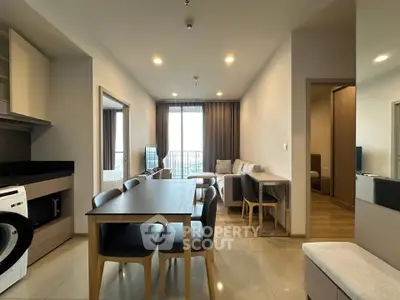 Modern open-plan living and dining area with sleek furniture and natural light.